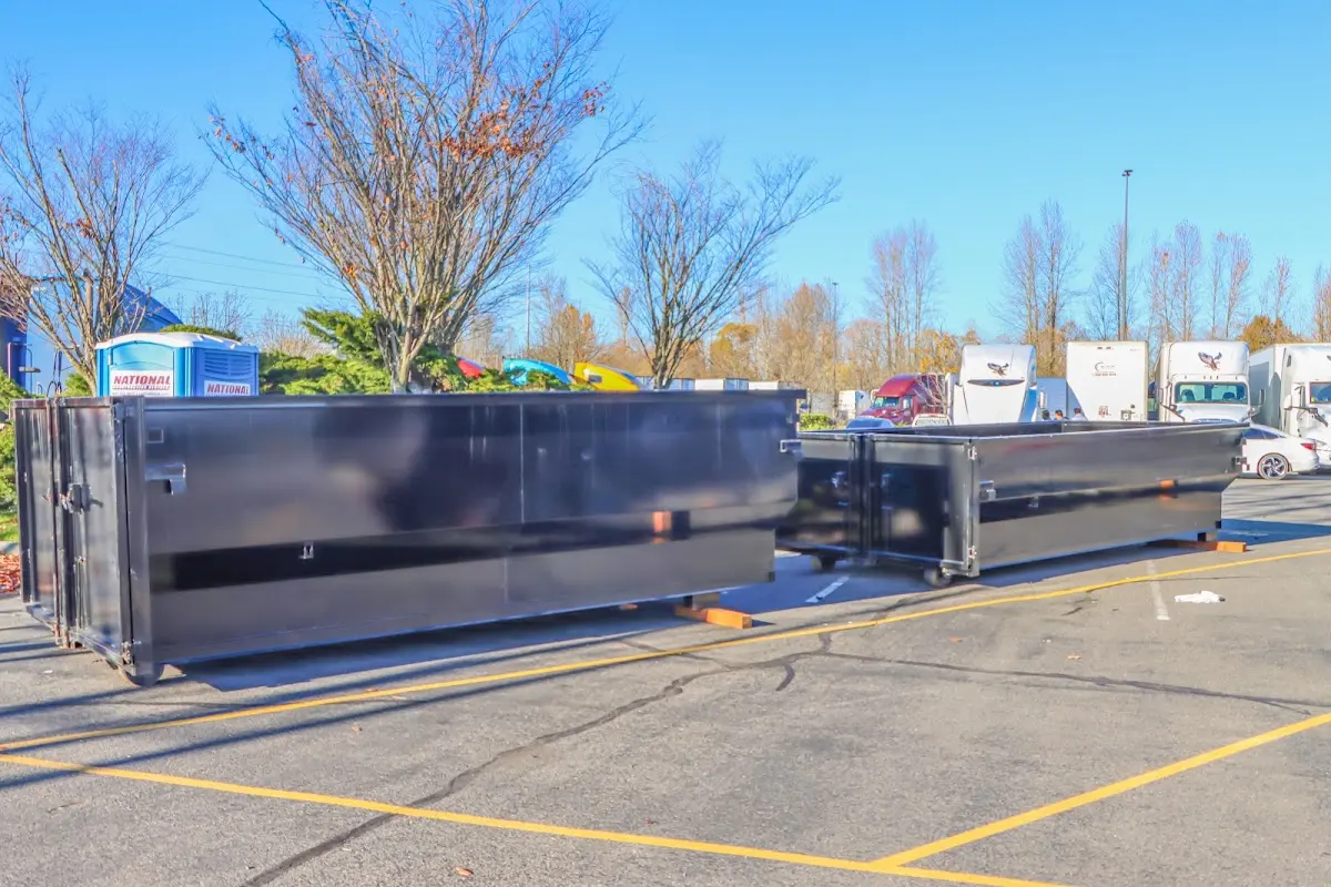 Professional dumpster rental service with roll-off container on residential driveway in Harriman